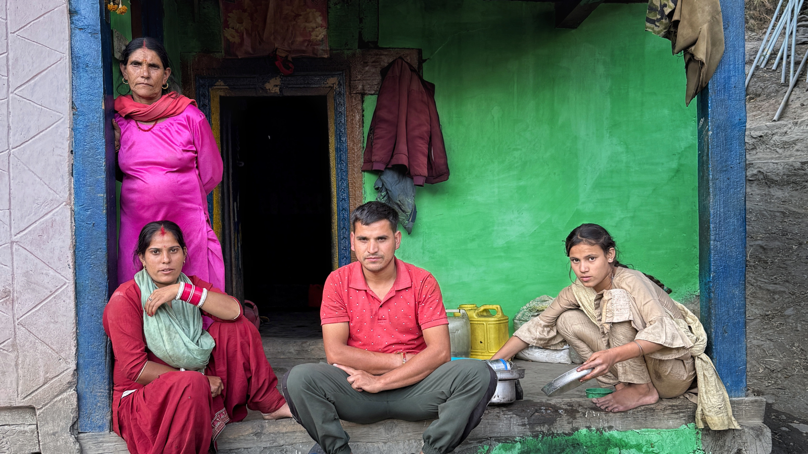 Four people sitting on patio in Pakistan near the River Chenab