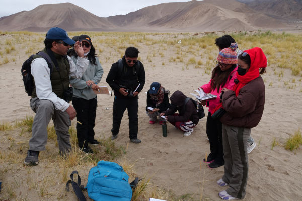 group of people on mountain plain