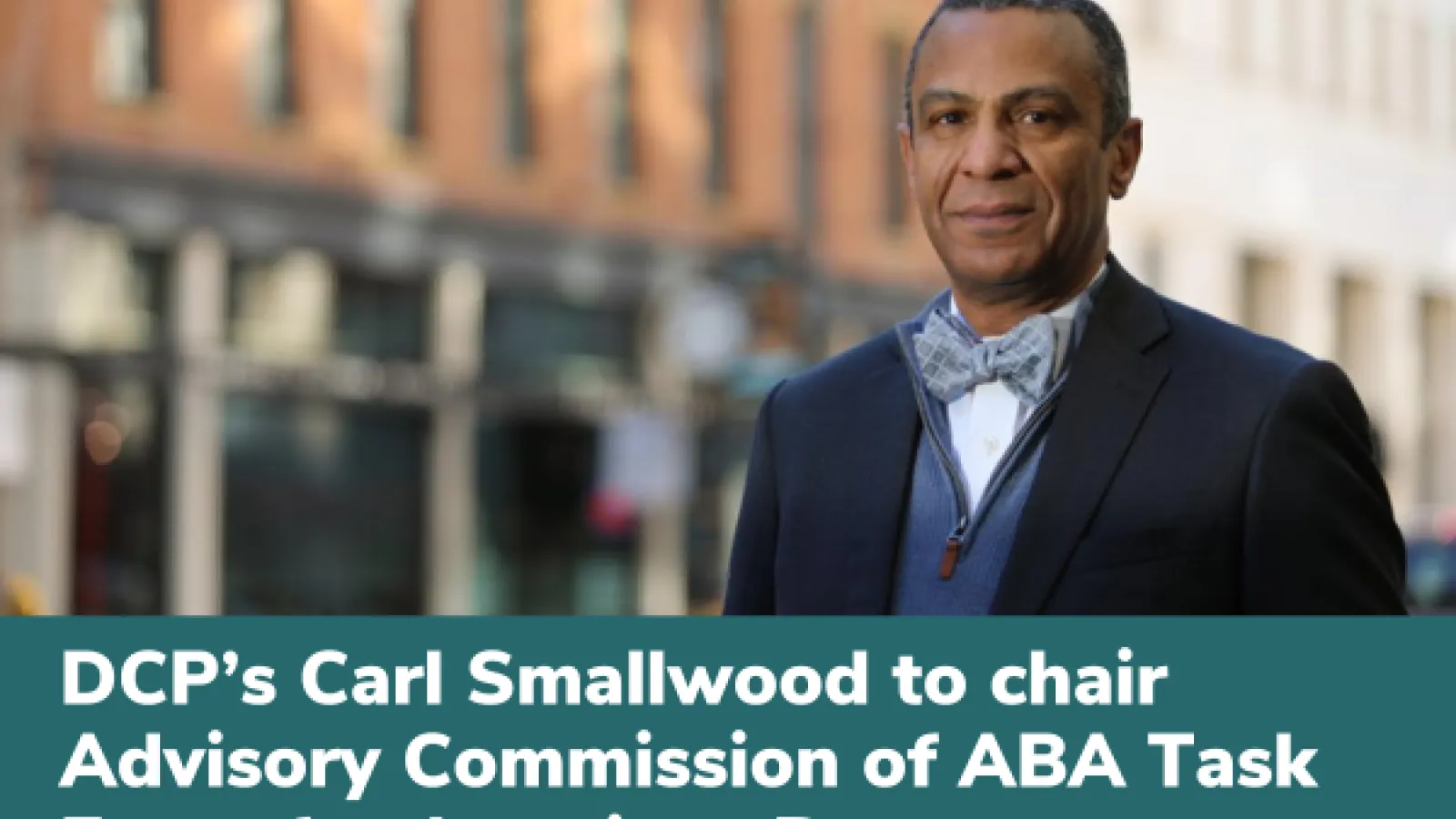 Carl Smallwood standing in a downtown main street setting.