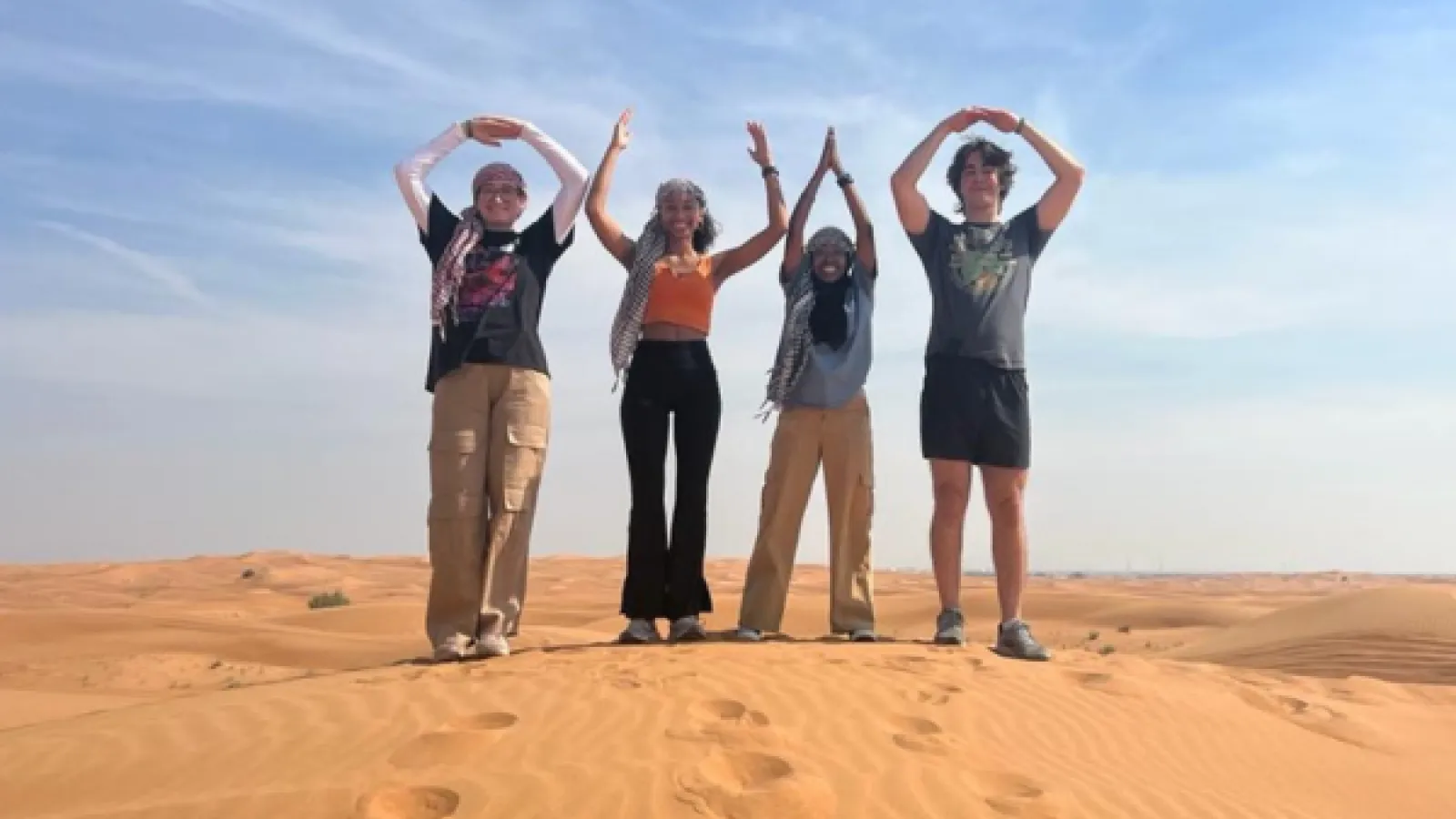 Students in desert forming the letters O.H.I.O. with hands over their head