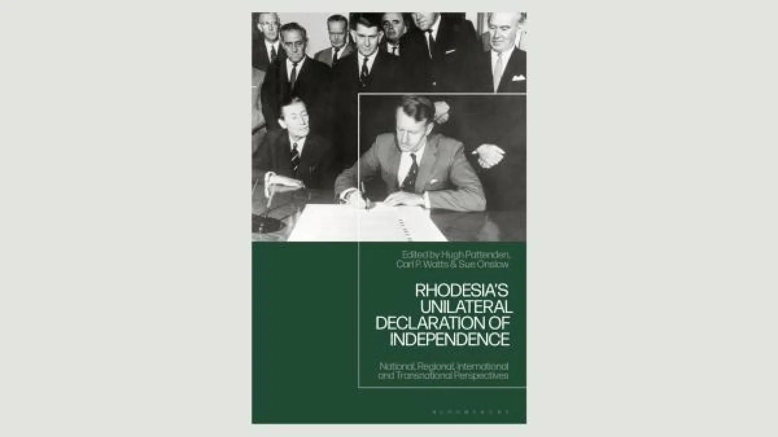 book cover with black and white photo of man signing document