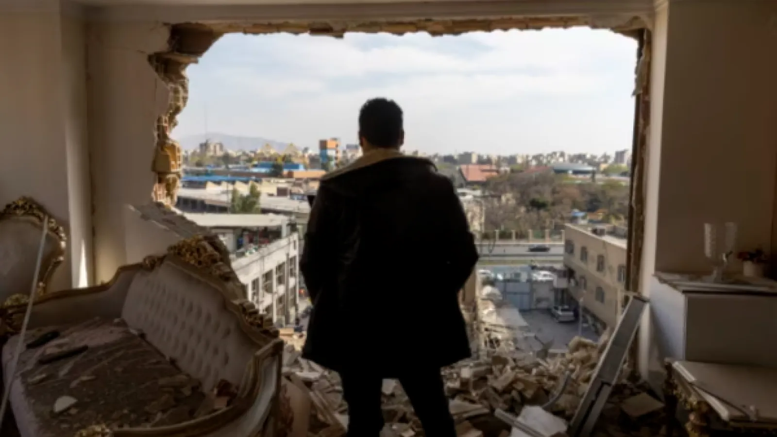 A man surveys the damage following strikes in Tehran.