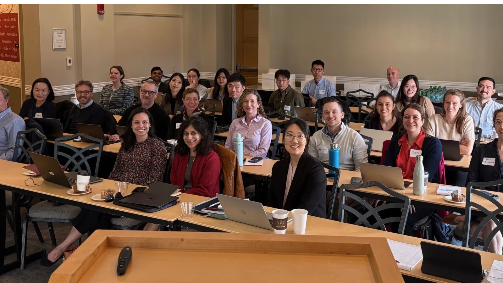 2 dozen people sitting at desks