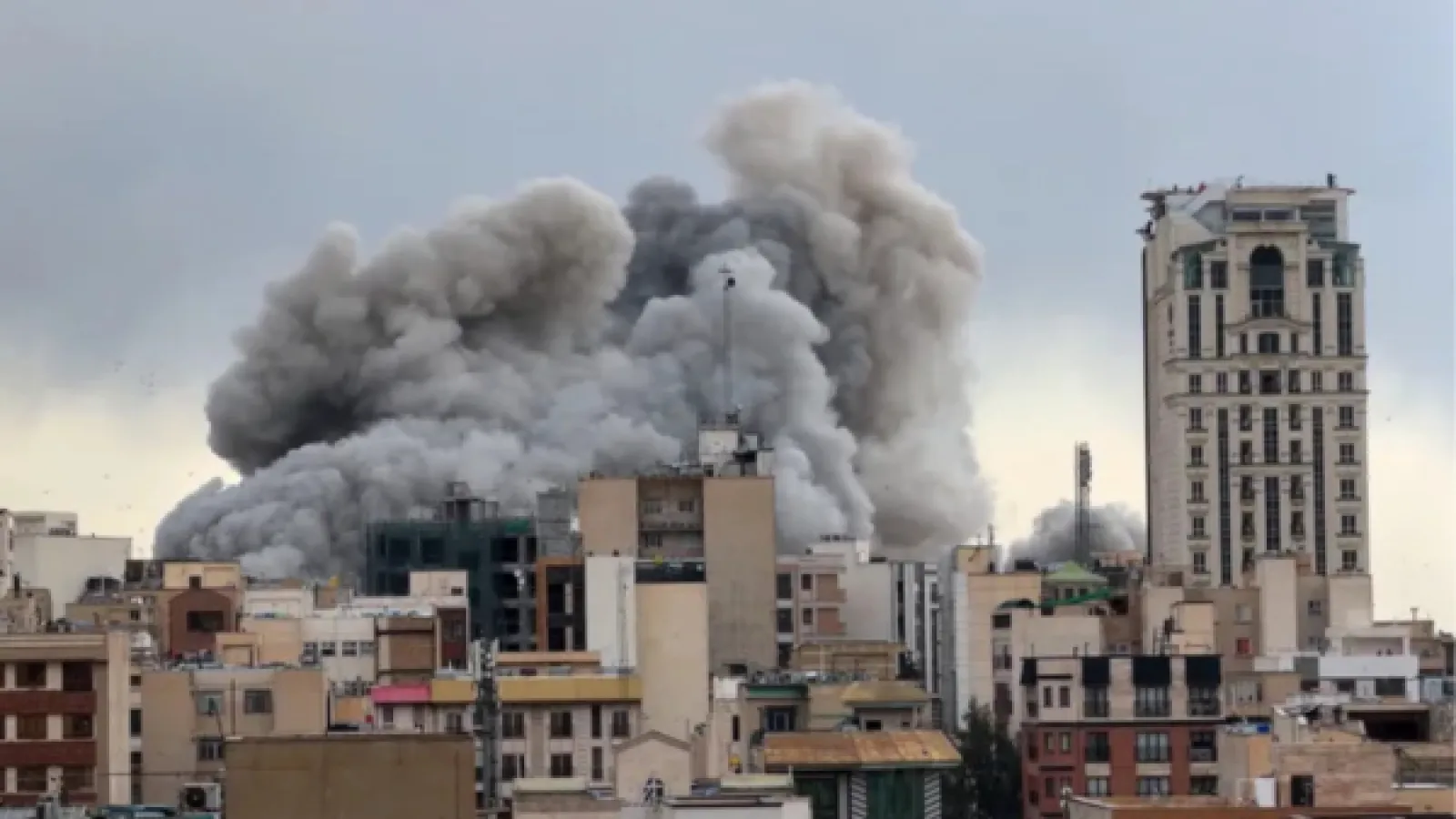 A plume of smoke rises over an attack on Tehran, Iran on March 2, 2026