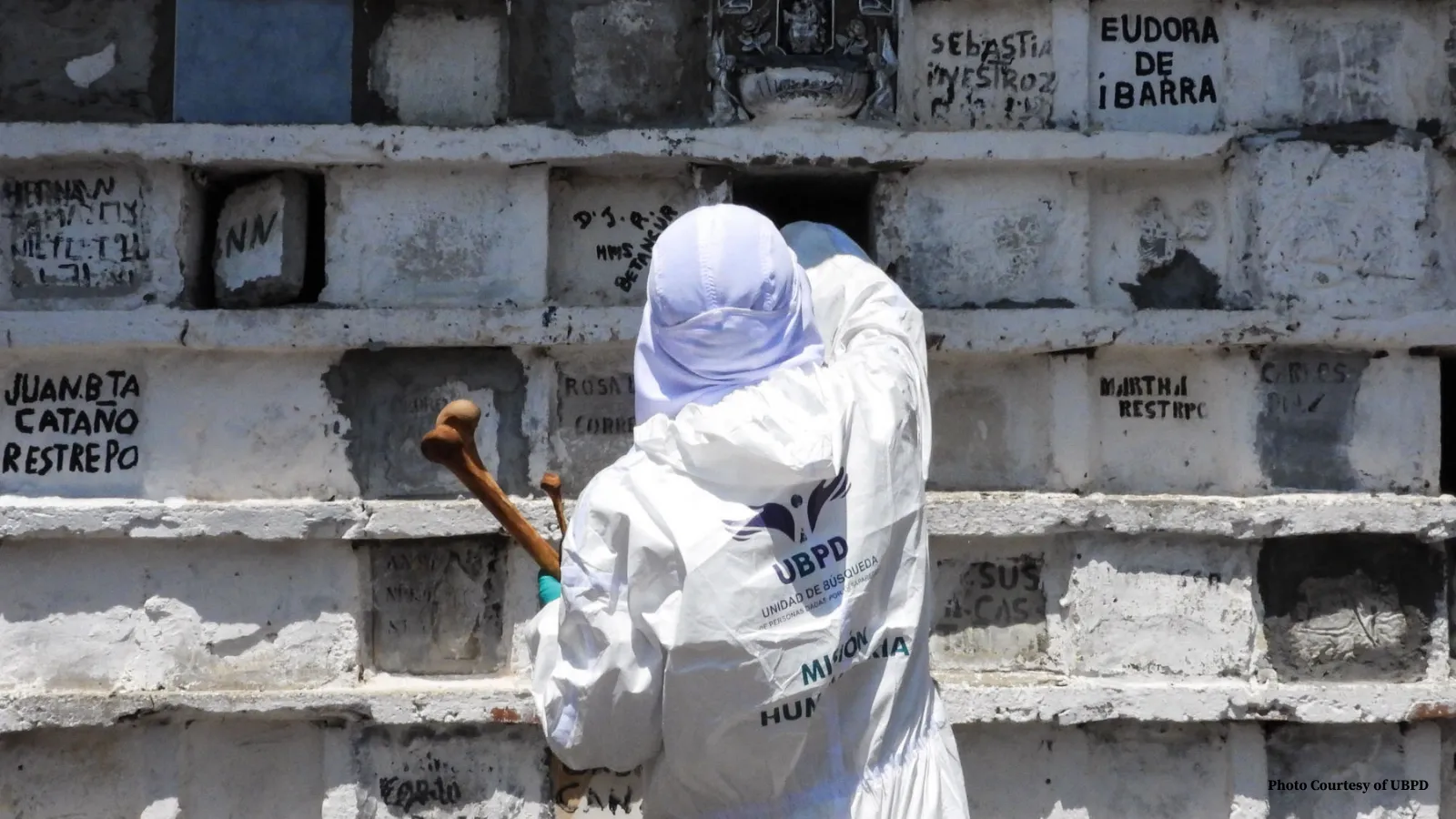 Forensic scientist in front of graves