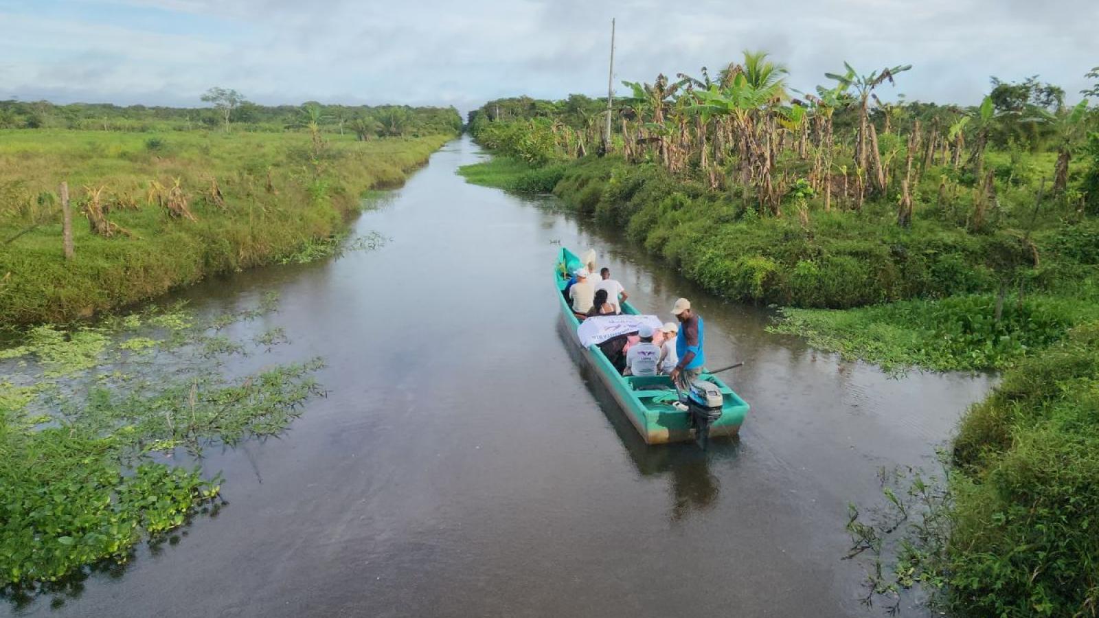 Flat bed boat floating down a river