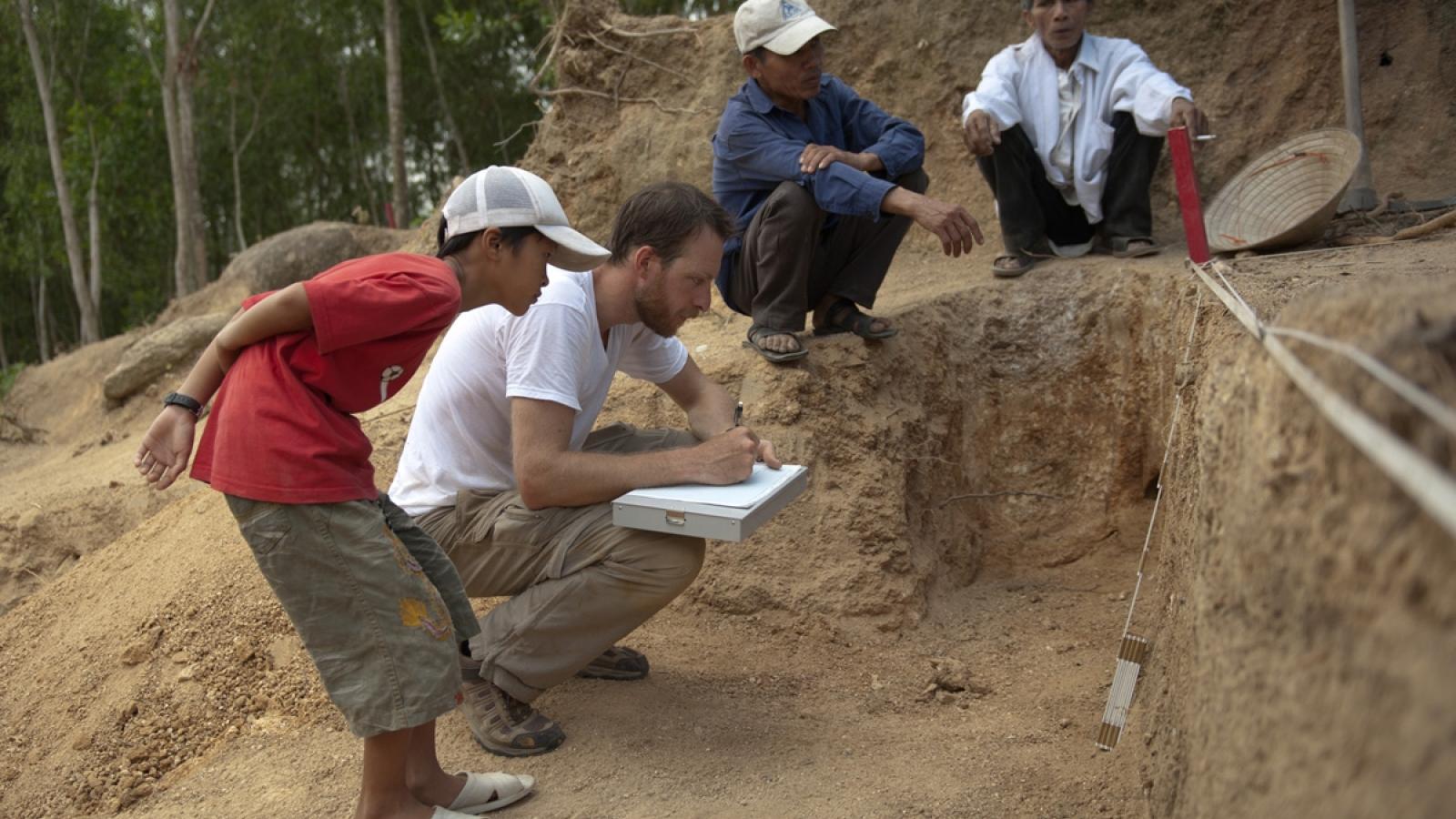 Group of people drawing soil samples