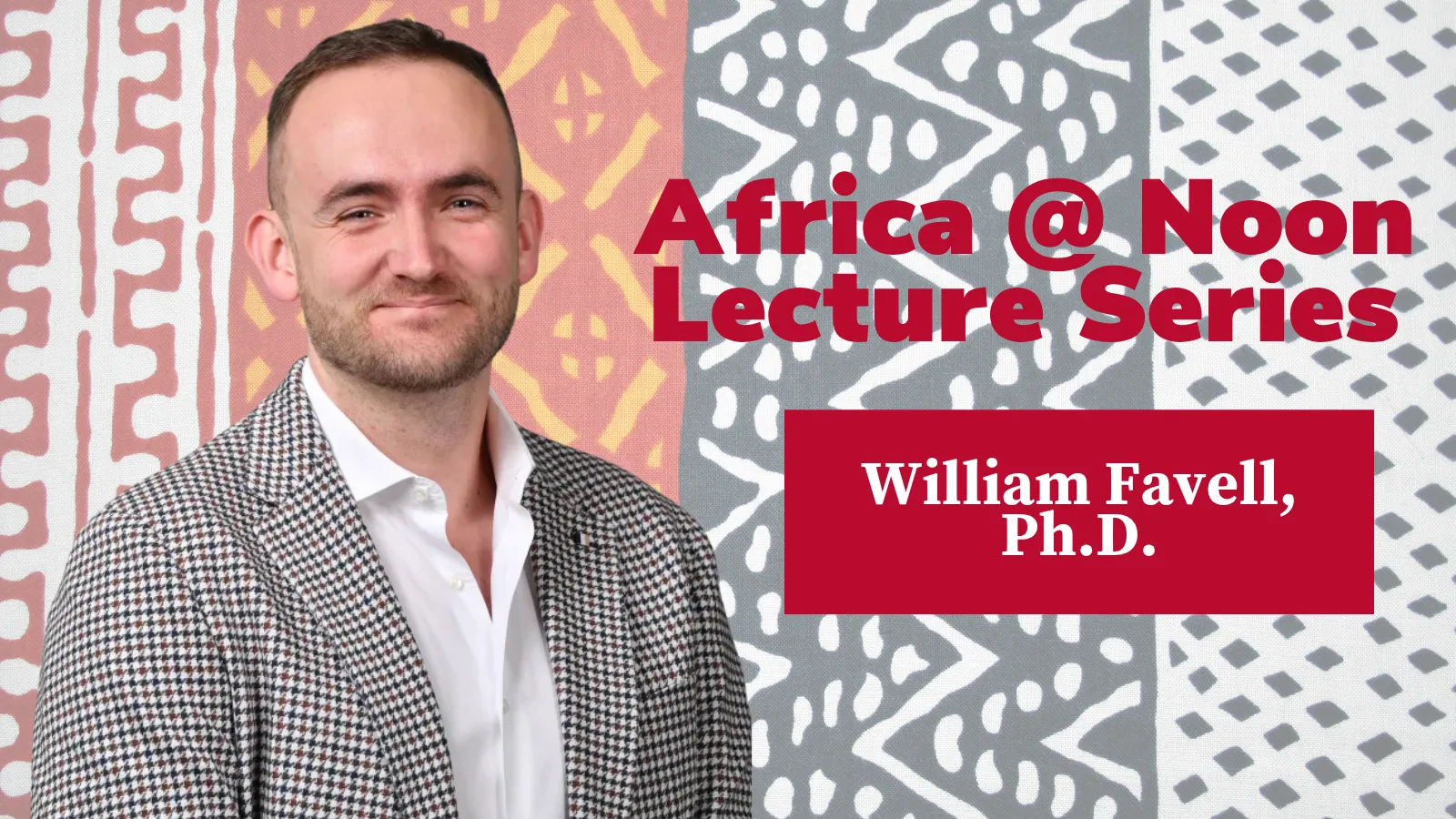 William Favell with a background of African cloth in red, orange, black and white