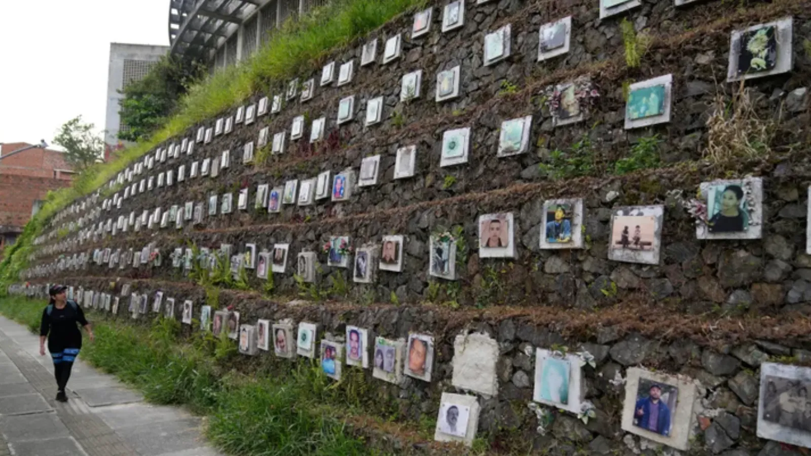 Gravesite with photos of people on a hill of dirt