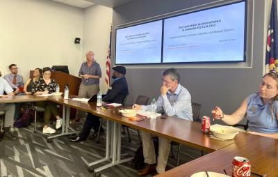 people at a conference table listening to a presentation