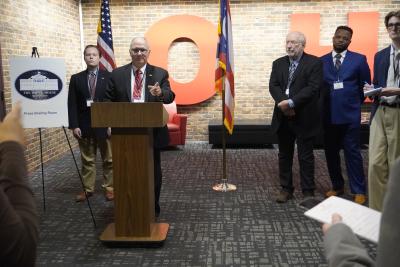 Man at podium answering questions