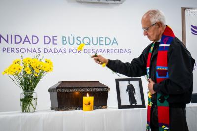 Father Giraldo blessing the remains of Father Torres
