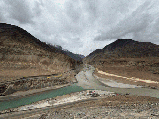 Confluence of two rivers below mountains