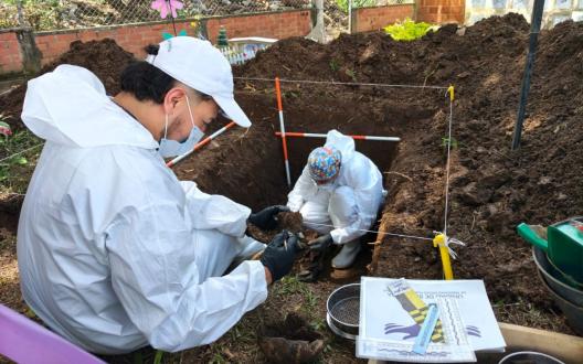 Forensic scientist exhuming remains