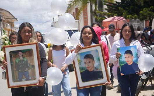 Family members hold pictures of disappeared loved ones