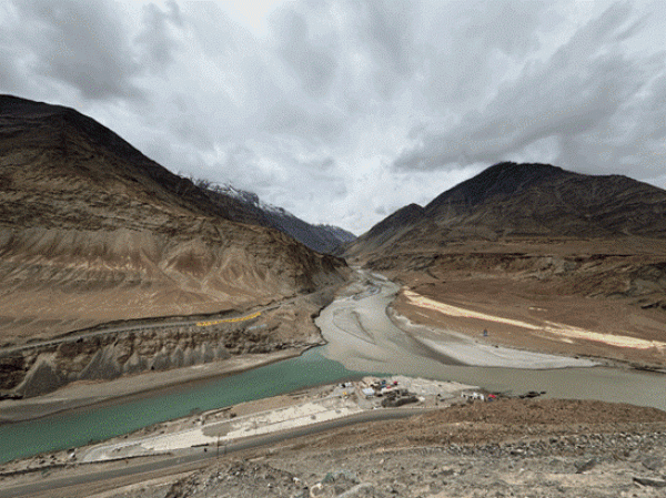 Confluence of two rivers below mountains