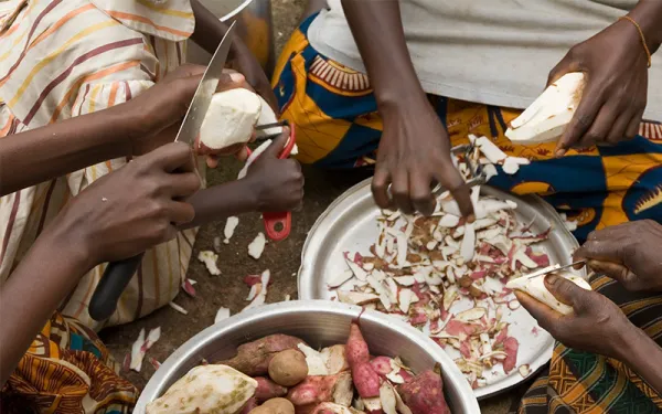 Burundi women peeling sweet potatos
