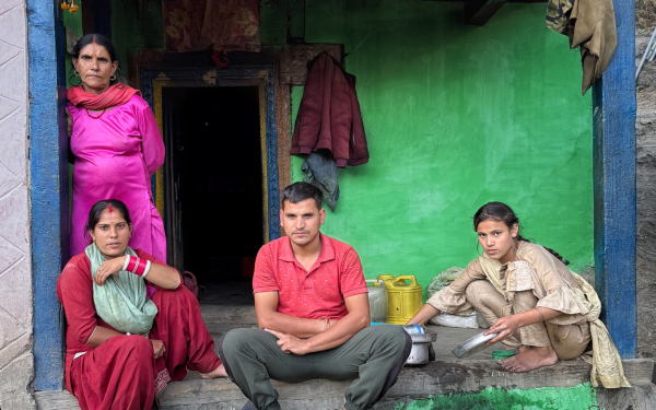 Four people sitting on patio in Pakistan near the River Chenab