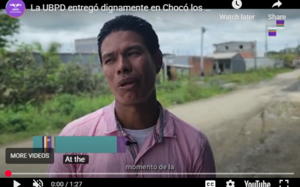 Man with dark hair in short sleeve pink shirt