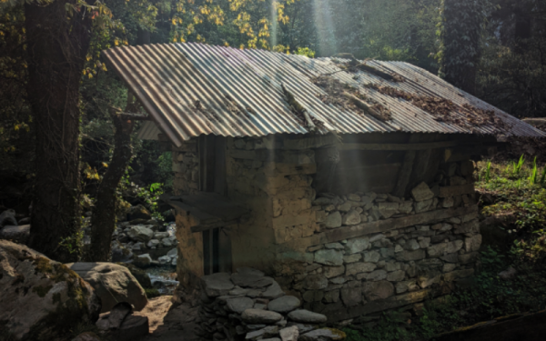 small slate shelter with sloping roof that looks like a tiny shrine