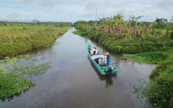 Flat bed boat floating down a river