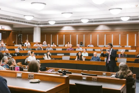 People in conference room listening to speaker