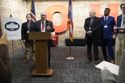 Man at podium answering questions