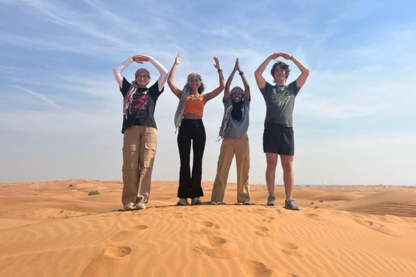 Students in desert forming the letters O.H.I.O. with hands over their head