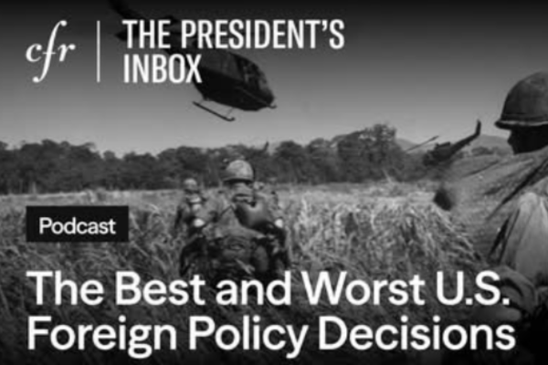 Black and white photo of soldiers and a helicopter