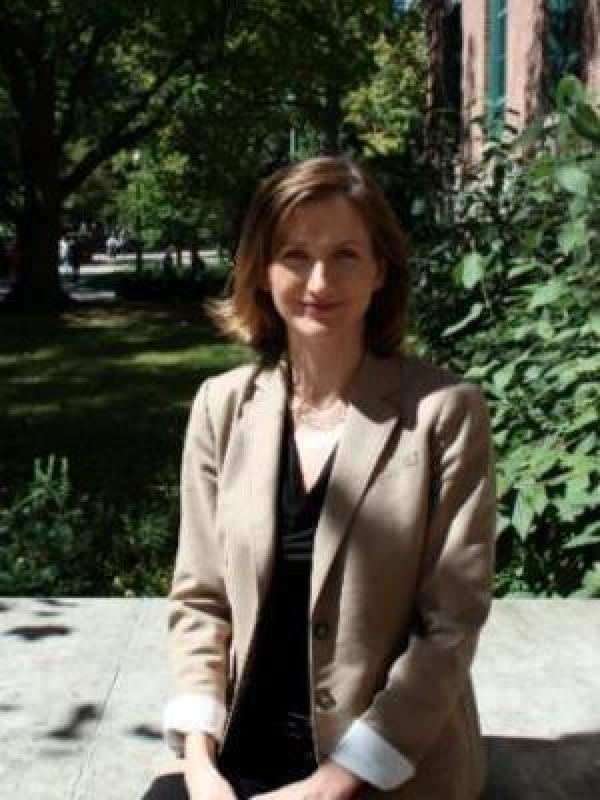 Portrait of Sarah Brooks outside of Derby Hall in a tan blazer.