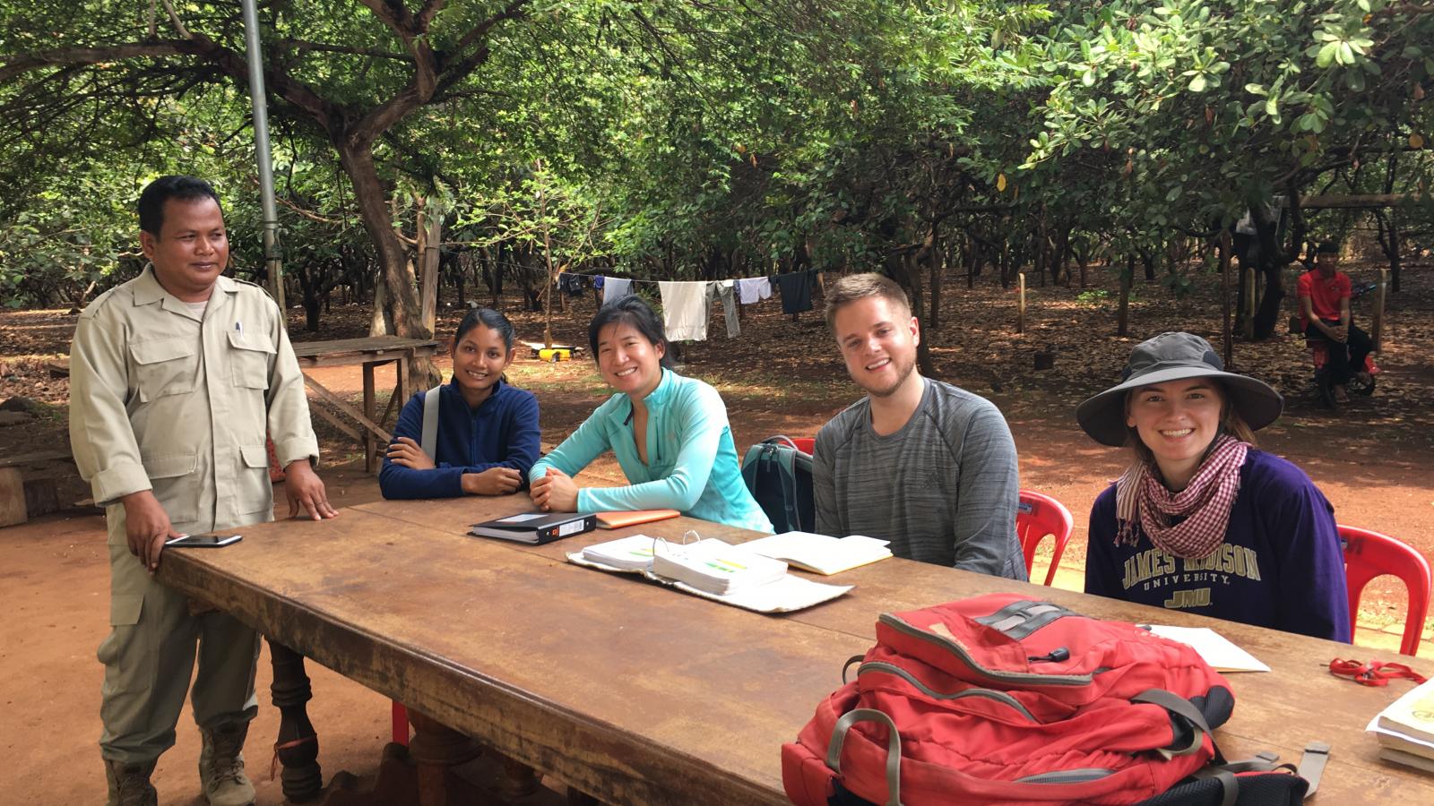 Erin Lin in Cambodia at a table with others