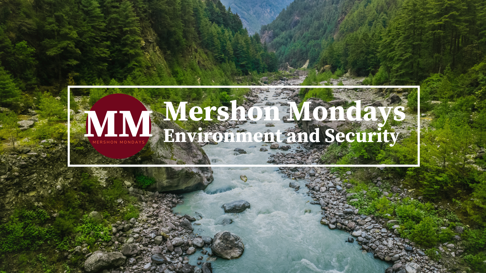 River with green mountains on either side